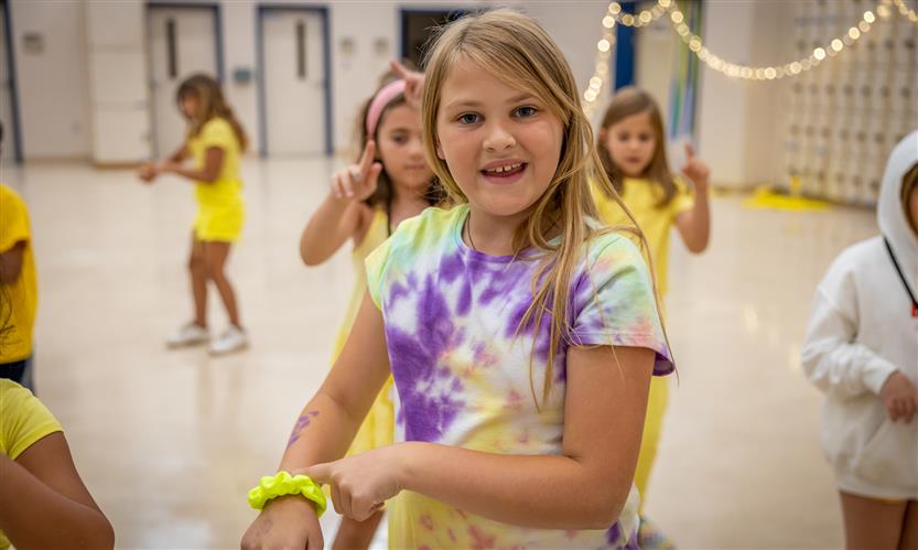 Girl smiles while dancing